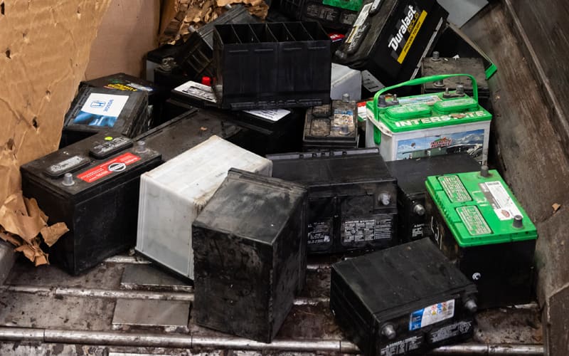 Used car batteries going into a hammer mill to be broken apart and separated in the recycling process. Used car batteries going into a hammer mill to be broken apart and separated in the recycling process.