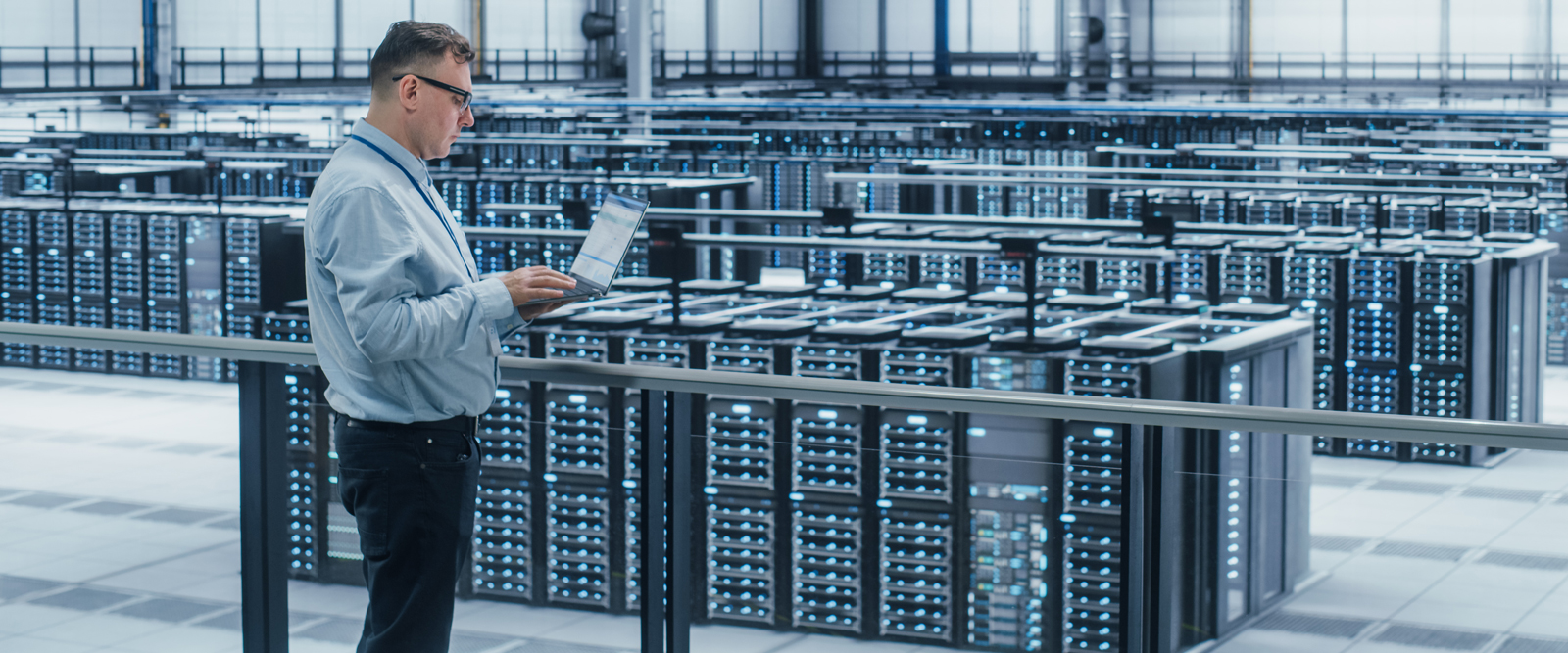 A man working in a data center that is supported by lead battery back-up power.